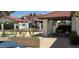 A relaxing poolside view featuring lush plantings, seating, and shade structures at 2831 E Waltann Ln # 1, Phoenix, AZ 85032