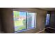 Bright room featuring a large window with a view of the community's lush landscaping and neighborhood at 2831 E Waltann Ln # 1, Phoenix, AZ 85032