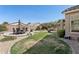 Well-maintained backyard with outdoor seating area, grill, manicured landscaping, and desert plants at 29839 N Little Leaf Dr, San Tan Valley, AZ 85143