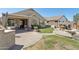 Well-maintained backyard featuring a covered patio, green grass, and a cozy outdoor seating area at 29839 N Little Leaf Dr, San Tan Valley, AZ 85143