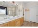 Bright bathroom features a double sink vanity, a large mirror, and a separate tub and shower at 29839 N Little Leaf Dr, San Tan Valley, AZ 85143