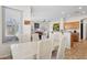 Dining area showcasing a bright room featuring a white dining table set, and adjacent living area at 29839 N Little Leaf Dr, San Tan Valley, AZ 85143