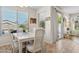 Bright dining area features a white dining set, lots of natural light, and a sliding glass door to the exterior at 29839 N Little Leaf Dr, San Tan Valley, AZ 85143