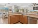 Well-lit kitchen featuring stainless steel appliances, wooden cabinets, and a convenient breakfast bar area at 29839 N Little Leaf Dr, San Tan Valley, AZ 85143