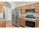 Bright kitchen featuring stainless steel appliances, wooden cabinetry, and modern fixtures for cooking at 29839 N Little Leaf Dr, San Tan Valley, AZ 85143
