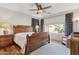 Spacious main bedroom boasts wood floors, large windows, stylish curtains, and ceiling fan at 29839 N Little Leaf Dr, San Tan Valley, AZ 85143