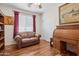 Inviting office with hardwood floors, leather sofa, lots of natural light, and a wooden desk at 29839 N Little Leaf Dr, San Tan Valley, AZ 85143