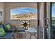 Balcony area with comfortable seating and scenic mountain views in the background at 3236 E Chandler Blvd # 2018, Phoenix, AZ 85048