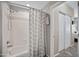 Shower-tub combination with grey patterned curtain next to a closet door at 3236 E Chandler Blvd # 2018, Phoenix, AZ 85048