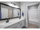 Bathroom featuring double sinks, a large mirror with lights, and a shower-tub combination at 3236 E Chandler Blvd # 2018, Phoenix, AZ 85048