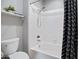 Well-lit bathroom featuring a combined tub and shower with white tiling and patterned shower curtain at 3236 E Chandler Blvd # 2018, Phoenix, AZ 85048