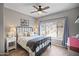 Comfortable bedroom features stylish decor, a ceiling fan, and a window overlooking the desert landscape at 3236 E Chandler Blvd # 2018, Phoenix, AZ 85048