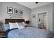 Bedroom featuring modern design elements, a ceiling fan, decor, and an ensuite bathroom at 3236 E Chandler Blvd # 2018, Phoenix, AZ 85048