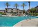 Resort-style pool area with palm trees and a beautiful waterfall feature at 3236 E Chandler Blvd # 2018, Phoenix, AZ 85048