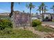 Elegant stone sign at Mountain Canyon Condominium Residences entry with manicured landscaping at 3236 E Chandler Blvd # 2018, Phoenix, AZ 85048