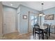 Bright dining room with blue walls, tile floors, and an adjacent door at 3236 E Chandler Blvd # 2018, Phoenix, AZ 85048