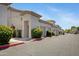 Exterior view of condos featuring private garages and manicured shrubbery at 3236 E Chandler Blvd # 2018, Phoenix, AZ 85048