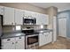 Kitchen with white cabinets, stainless steel appliances, and tile flooring at 3236 E Chandler Blvd # 2018, Phoenix, AZ 85048