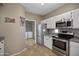Well-lit kitchen with modern appliances, white cabinetry, and access to the laundry area at 3236 E Chandler Blvd # 2018, Phoenix, AZ 85048