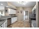 Bright kitchen featuring white cabinetry, stainless steel appliances, and access to the laundry room at 3236 E Chandler Blvd # 2018, Phoenix, AZ 85048