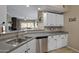Kitchen area showcasing stainless steel appliances and an open layout to the living room at 3236 E Chandler Blvd # 2018, Phoenix, AZ 85048
