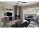 Living room with a stone fireplace, flat-screen TV, tile floors, and access to the outdoor balcony at 3236 E Chandler Blvd # 2018, Phoenix, AZ 85048