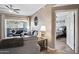 Cozy living room showcasing a ceiling fan, comfortable seating, and access to a balcony and bedroom at 3236 E Chandler Blvd # 2018, Phoenix, AZ 85048