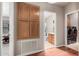 Hallway showing built-in wood cabinets adjacent to the bathroom and laundry room entrances at 3301 S Goldfield Rd # 1048, Apache Junction, AZ 85119