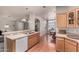 Bright kitchen features light-colored cabinets, hardwood floors, modern appliances, and an open floor plan at 3301 S Goldfield Rd # 1048, Apache Junction, AZ 85119