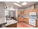 Well-lit kitchen features wood cabinets, light countertops, and modern appliances at 3301 S Goldfield Rd # 1048, Apache Junction, AZ 85119
