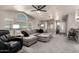 Spacious living room with vaulted ceilings, fan, large windows, and comfortable seating at 3301 S Goldfield Rd # 1048, Apache Junction, AZ 85119