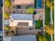 A bird's-eye view showcasing the backyard features: lawn, trampoline, blue patio umbrella, and solar panels at 36033 W Catalonia Dr, Maricopa, AZ 85138