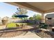 Charming backyard featuring an outdoor dining area and a relaxing egg chair at 36033 W Catalonia Dr, Maricopa, AZ 85138