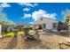 Inviting backyard features a fire pit, grassy area, and outdoor seating, perfect for relaxing and entertaining at 36033 W Catalonia Dr, Maricopa, AZ 85138
