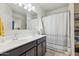Bathroom featuring double sinks and a shower with a modern curtain at 36033 W Catalonia Dr, Maricopa, AZ 85138