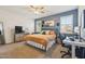 Cozy bedroom with a comfortable bed, modern furnishings, and ample natural light from the windows at 36033 W Catalonia Dr, Maricopa, AZ 85138