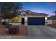 Charming single-Gathering home featuring a well-maintained front yard, blue garage door, and inviting curb appeal at 36033 W Catalonia Dr, Maricopa, AZ 85138