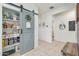 Hallway with open pantry including a sliding barn door and charming decorative accents at 36033 W Catalonia Dr, Maricopa, AZ 85138