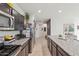 Spacious kitchen featuring granite countertops, stainless steel appliances, and an island, perfect for cooking and entertaining at 36033 W Catalonia Dr, Maricopa, AZ 85138
