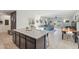 Bright and spacious kitchen with a large island, and an open floorplan layout to the living room at 36033 W Catalonia Dr, Maricopa, AZ 85138