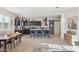 Bright and airy living area showcases an open kitchen with a large island and modern design at 36033 W Catalonia Dr, Maricopa, AZ 85138