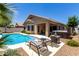 Backyard with a sparkling pool, lounge chairs, covered patio, and relaxing spa at 3719 E Sandy Way, Gilbert, AZ 85297