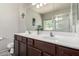 Bathroom with a double sink vanity, large mirror, and a glass-enclosed shower at 3719 E Sandy Way, Gilbert, AZ 85297