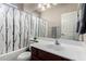 A neutral bathroom with a combination shower and tub, and a cherry vanity sink at 3719 E Sandy Way, Gilbert, AZ 85297
