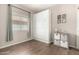 Neutral bedroom featuring plank flooring, a Murphy bed, and a window allowing for great light at 3719 E Sandy Way, Gilbert, AZ 85297