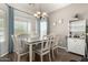 Bright dining room with a chandelier, large window, table for six, and a serving hutch at 3719 E Sandy Way, Gilbert, AZ 85297