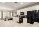 Bright kitchen features white cabinetry, black appliances, and a breakfast bar overlooking the dining area at 3719 E Sandy Way, Gilbert, AZ 85297