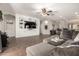 Spacious living room with a custom built-in entertainment center and wood-look floors at 3719 E Sandy Way, Gilbert, AZ 85297