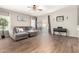 Spacious living room features a comfortable sectional, ceiling fan, and sliding glass doors to the outdoor area at 3719 E Sandy Way, Gilbert, AZ 85297