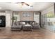 Comfortable living room featuring a large gray sectional, tile flooring, and access to the outdoor patio at 3719 E Sandy Way, Gilbert, AZ 85297
